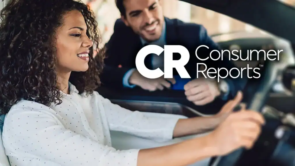 Woman smiling while seated in a car, engaged in conversation with a man leaning on the window. Consumer Reports logo.